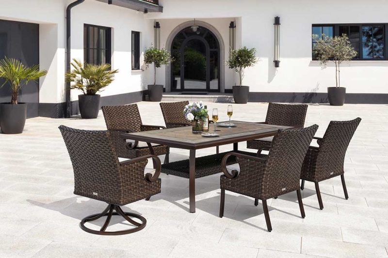 Handmade woven, all-weather wicker in a natural brown tone is accented and accompanied by gently curved armrests. Detailed with scrolled and finished aluminum, steady gray-toned cushions, and a marvelous ceramic tabletop.