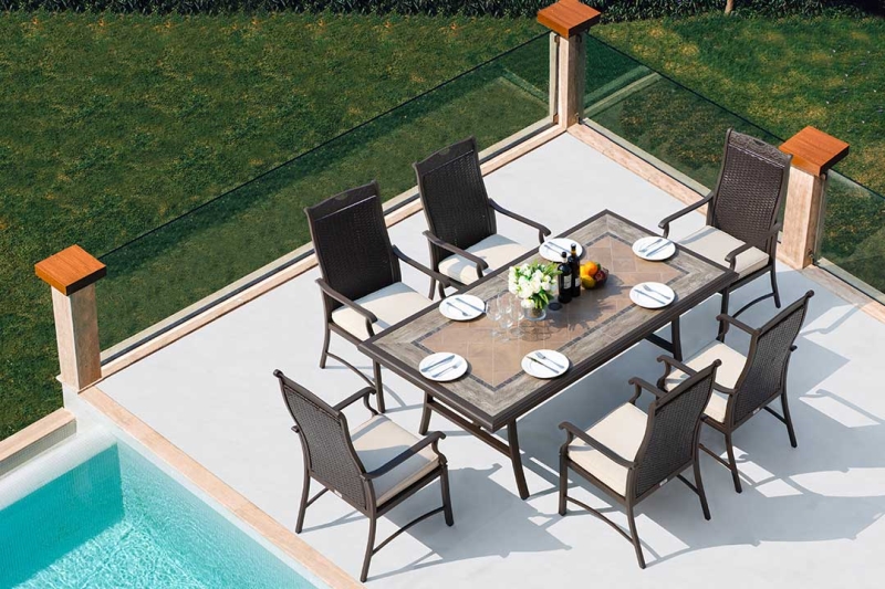 The exclusive Russell collection will impress you with the best comfort with a sophisticated tile table and six hand-woven all-weather wicker chairs. This dining set is sure to fascinate your guests in the summertime..